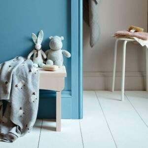 Nursery wall painted with Polka Dot (foreground) and Paw Print